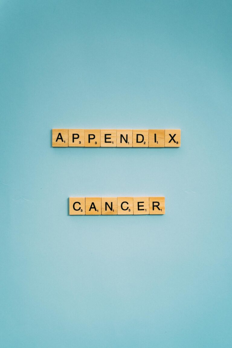 Scrabble tiles spelling 'Appendix Cancer' on a light blue background.